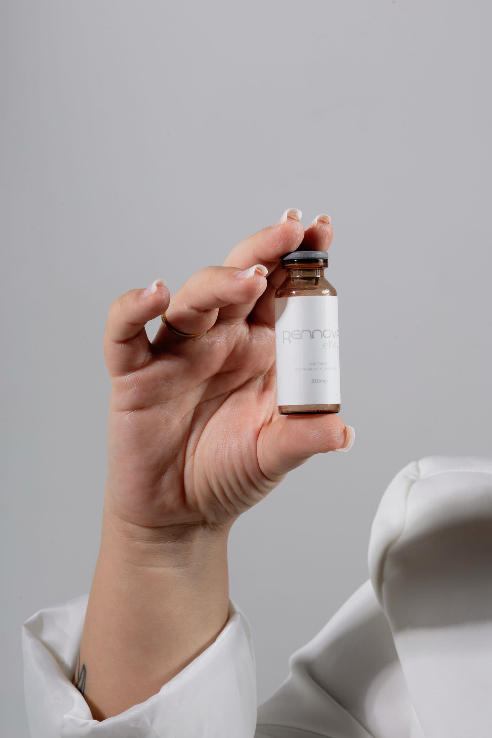 Hand hält ein Vial mit Referenzsubstanz